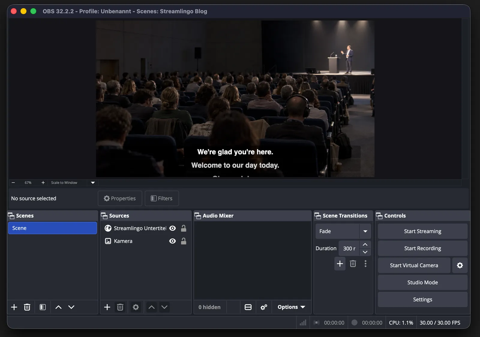 OBS Studio with a camera image of a conference hall and two English caption lines from Streamlingo laid over the bottom of the picture.